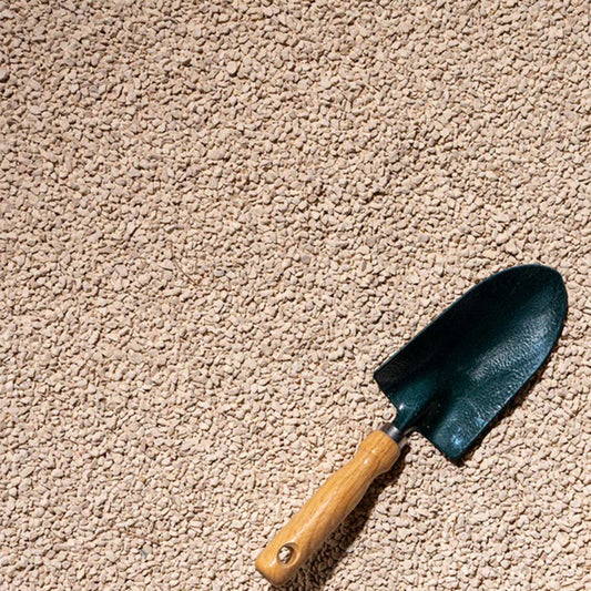 Beige 20kg gravel for plants, showing small 1cm to 2cm stones in a natural garden setting.