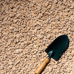 Beige gravel from Plant House, 20kg, suitable for plant landscaping, showing small 1-2cm stones on a garden surface.