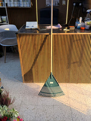 Plant House garden rake for planting, with metal tines and wooden handle, ideal for garden soil cultivation and raking leaves.