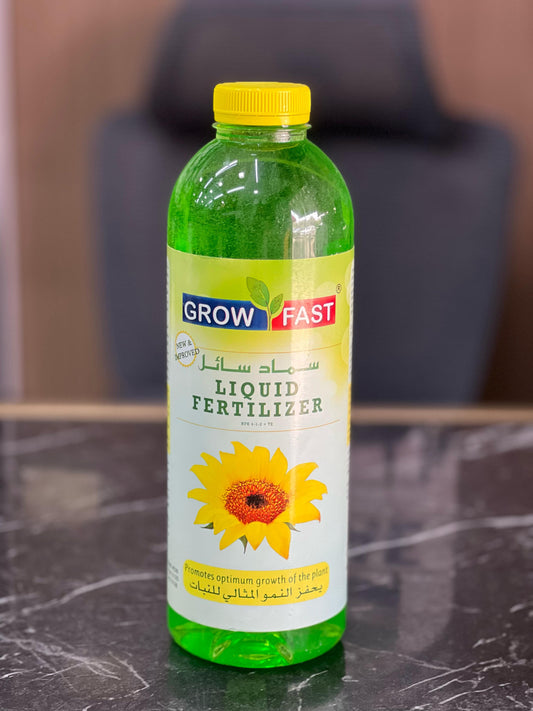 1-liter bottle of Plant House Grow Fast Liquid Fertilizer for healthy plant growth, shown in a clear container.