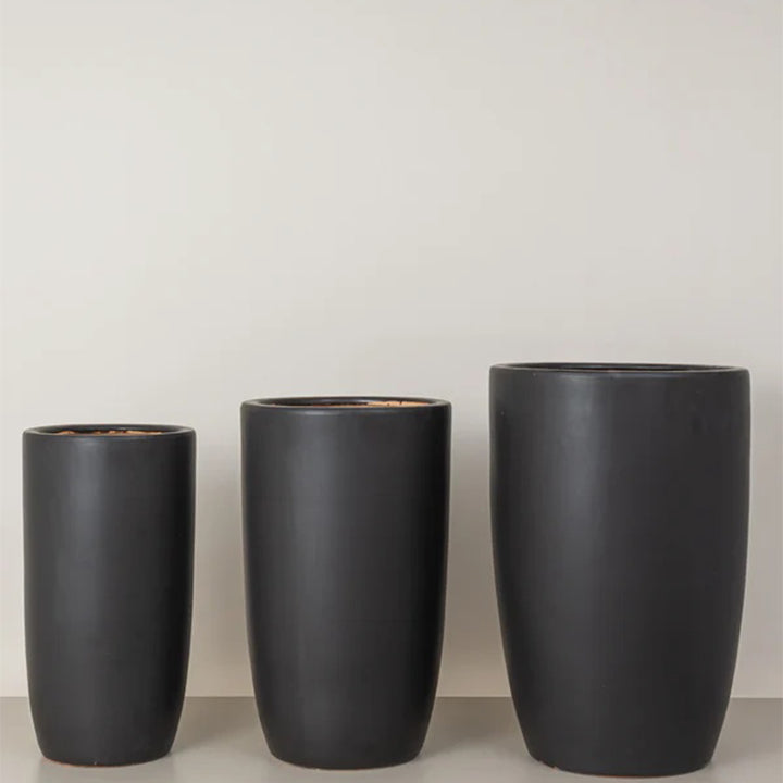 Medium tall black cremic plant pots from Plant House, suitable for indoor or outdoor plants with stylish, modern design.