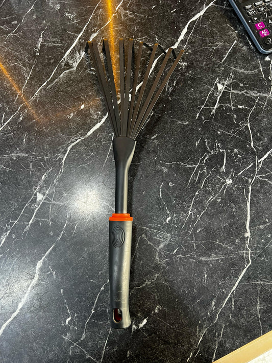 Garden hand rake from Plants House Gardening Work LLC, featuring metal tines and a wooden handle for garden soil cultivation.